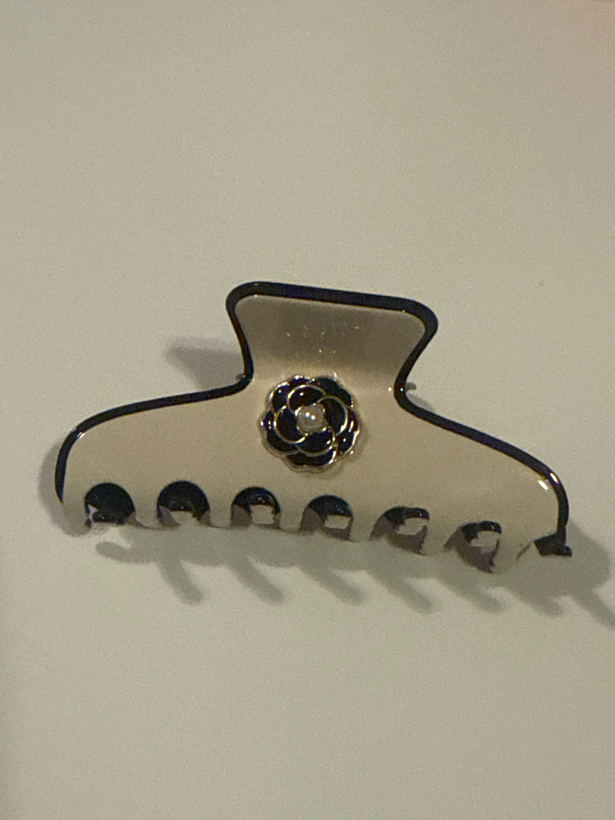 Clip with black and gold camellia flower